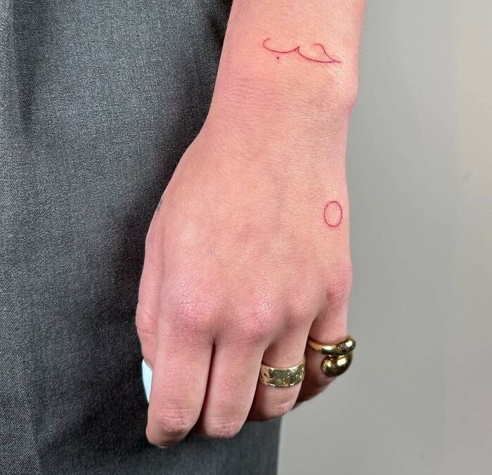 Minimalist Red Ink Hand Tattoo with Abstract Symbols Tattoo Design