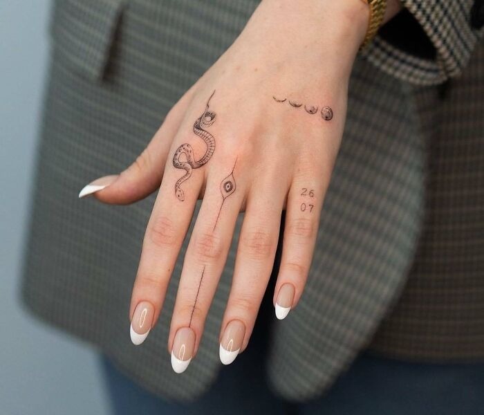 Snake and Moon Phases Hand Tattoo with Minimalist Details Tattoo Design