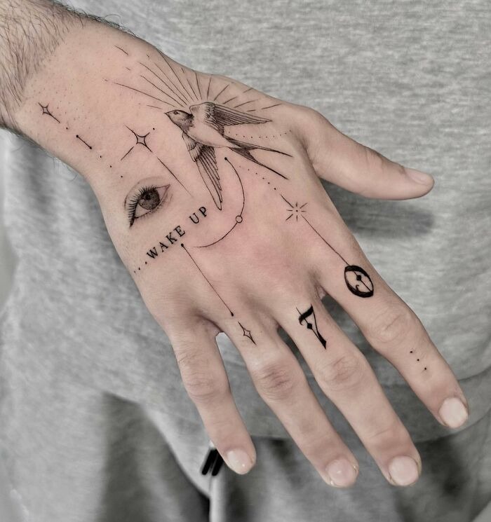 “Wake Up” Symbolic Hand Tattoo with Swallow and Celestial Elements Tattoo Design