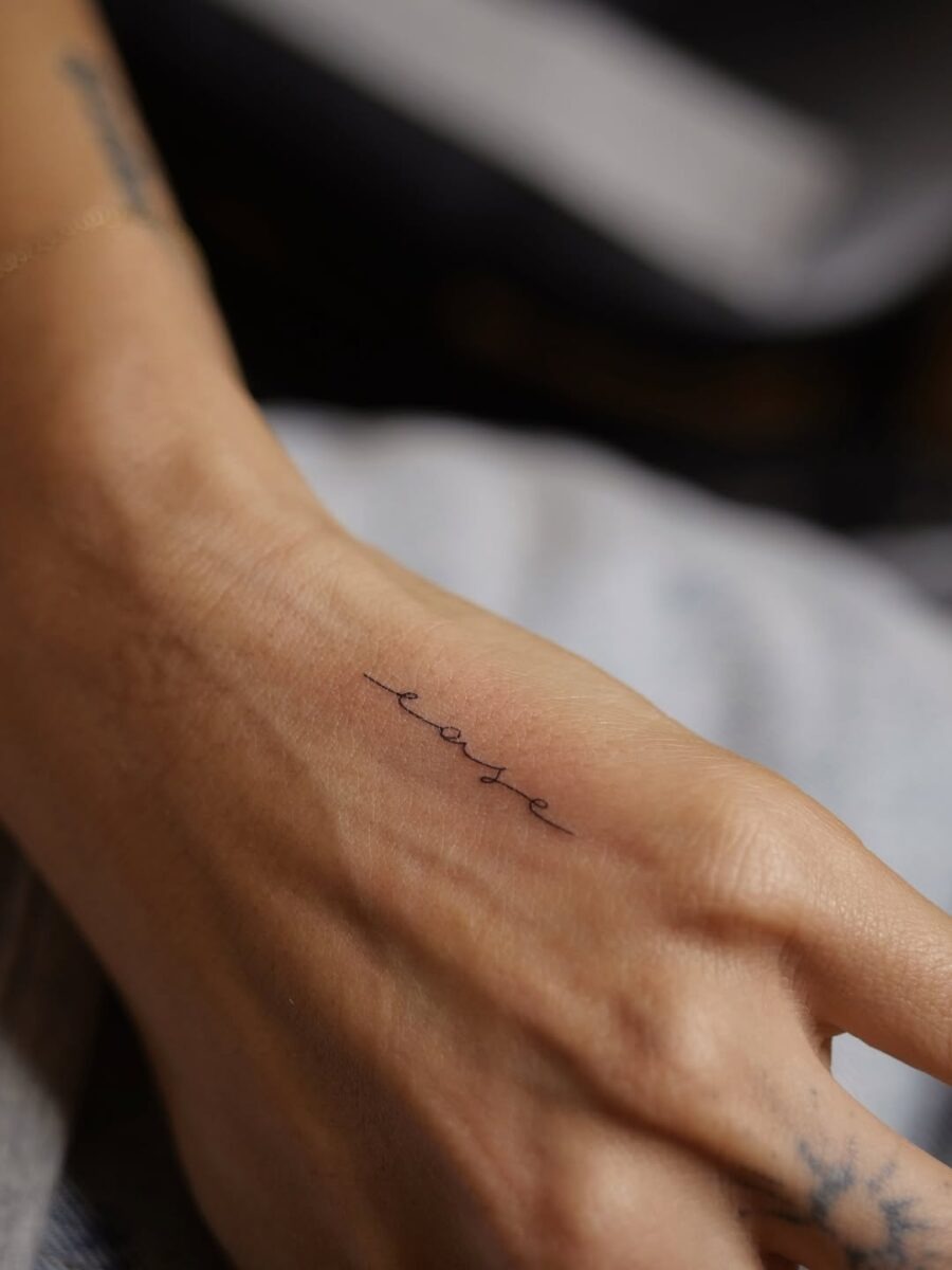 Delicate Handwriting Tattoo of the Word 'Ease' Tattoo Design