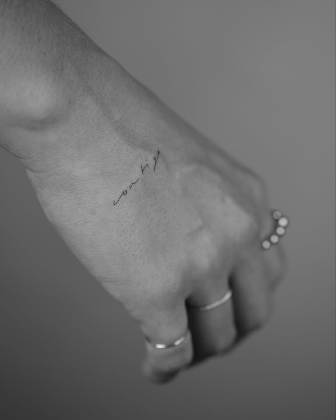 Elegant handwriting tattoo on wrist area Tattoo Design
