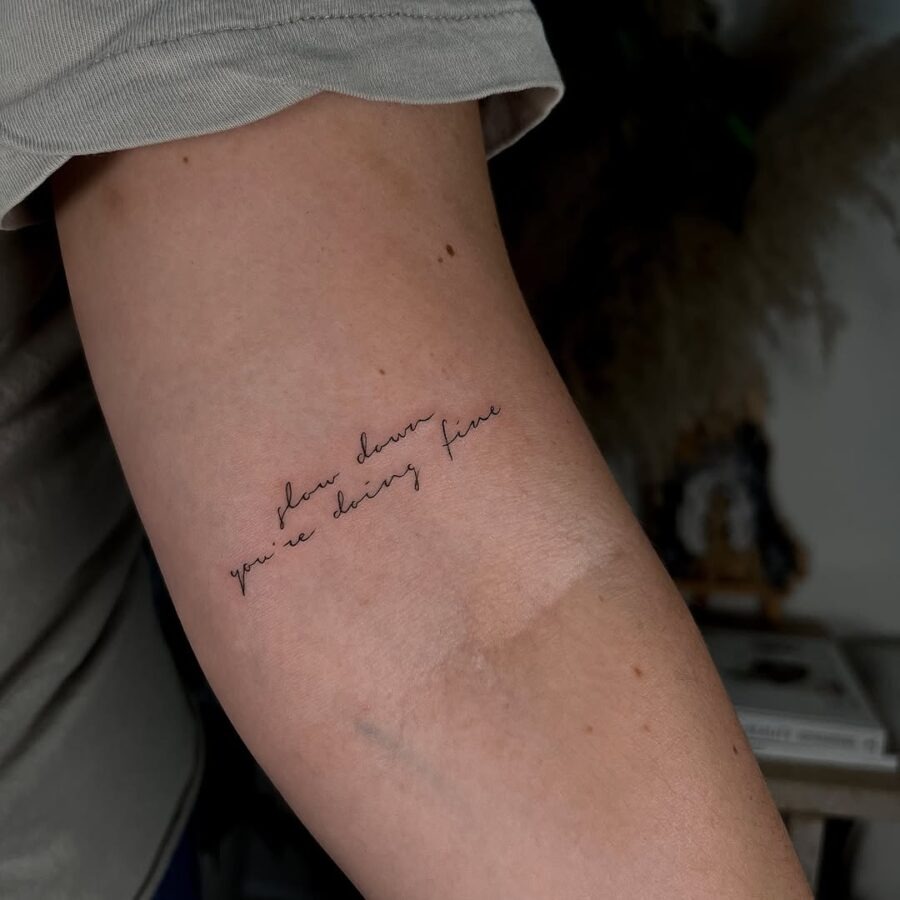 Elegant script tattoo with a motivational quote Tattoo Design