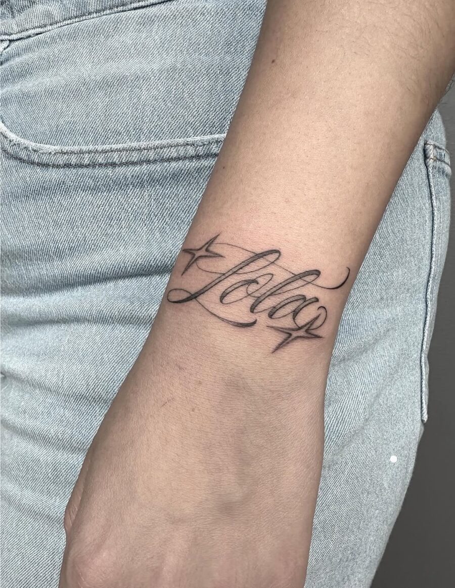 Elegant scripted handwriting tattoo on wrist Tattoo Design