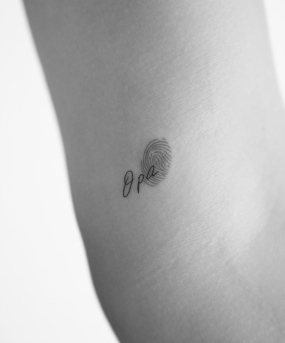 Minimalist fingerprint with elegant script Tattoo Design