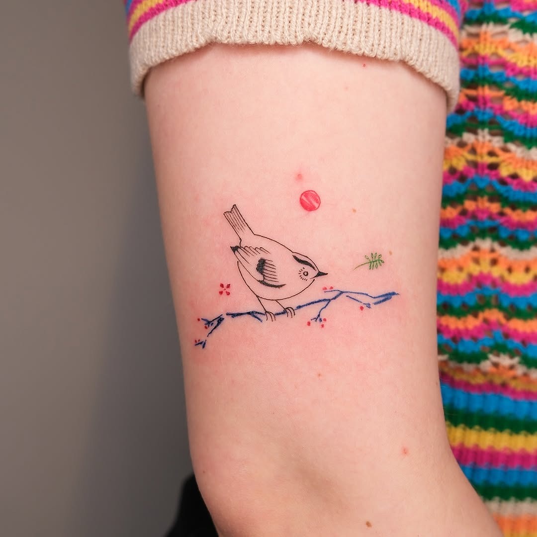Charming bird tattoo perched on a branch Tattoo Design
