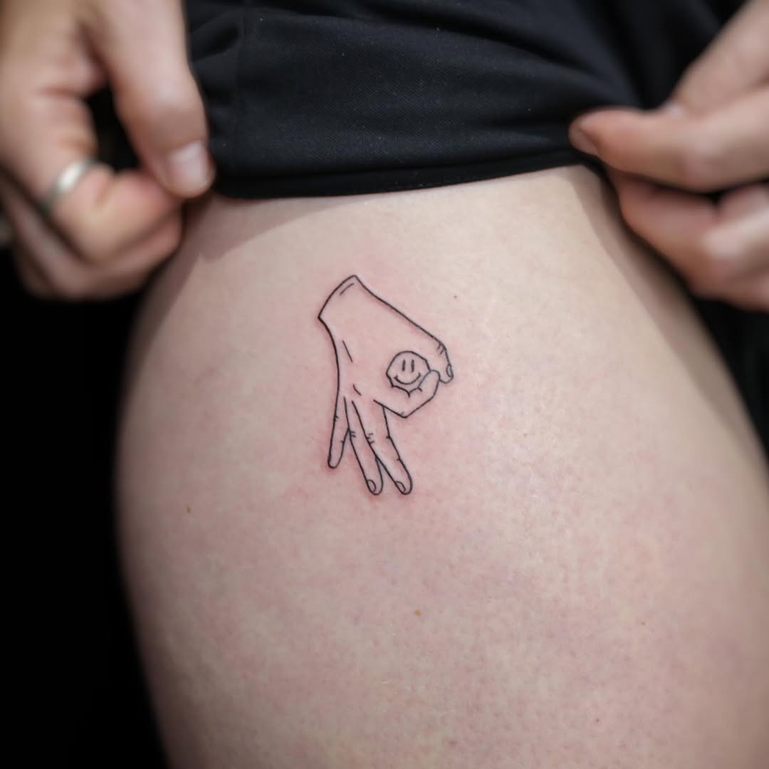 Cute hand gesture tattoo radiates positivity Tattoo Design