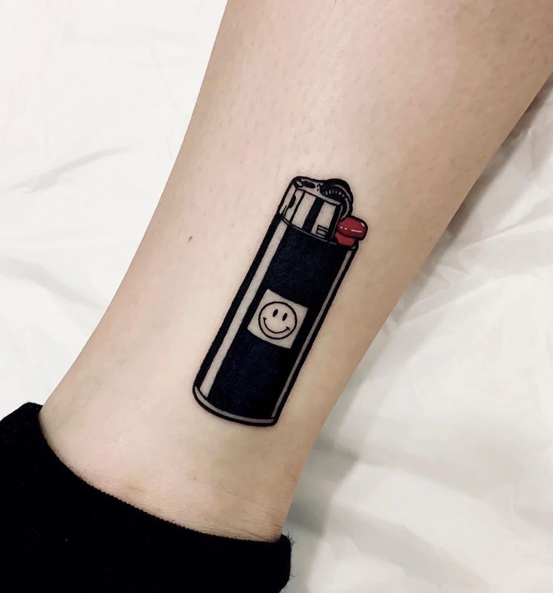 Quirky lighter tattoo with a smiley face Tattoo Design