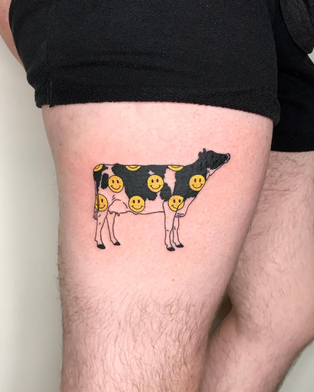 Whimsical cow tattoo with cheerful smilies Tattoo Design