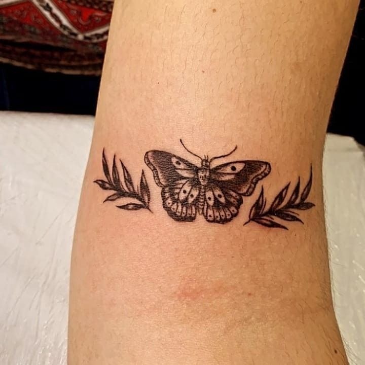 Butterfly with Botanical Balance, a tattoo design rendered in clean detailed linework for the leg.
