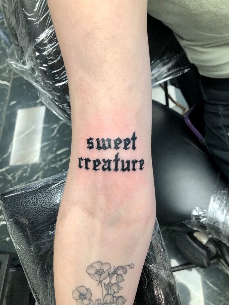 Sweet Creature Gothic Lettering Tattoo, a tattoo design rendered in delicate fine-line.