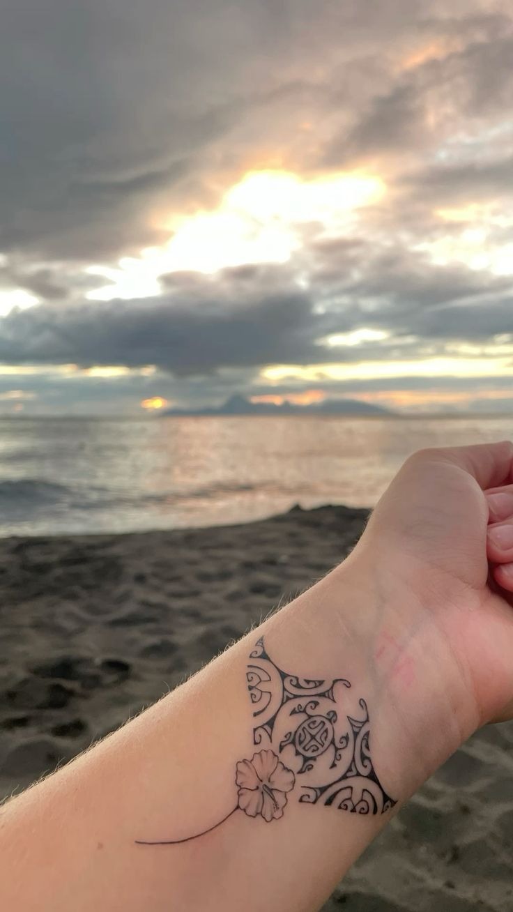 Simple Wrist Polynesian Band with Tiny Flower Detail Tattoo Design