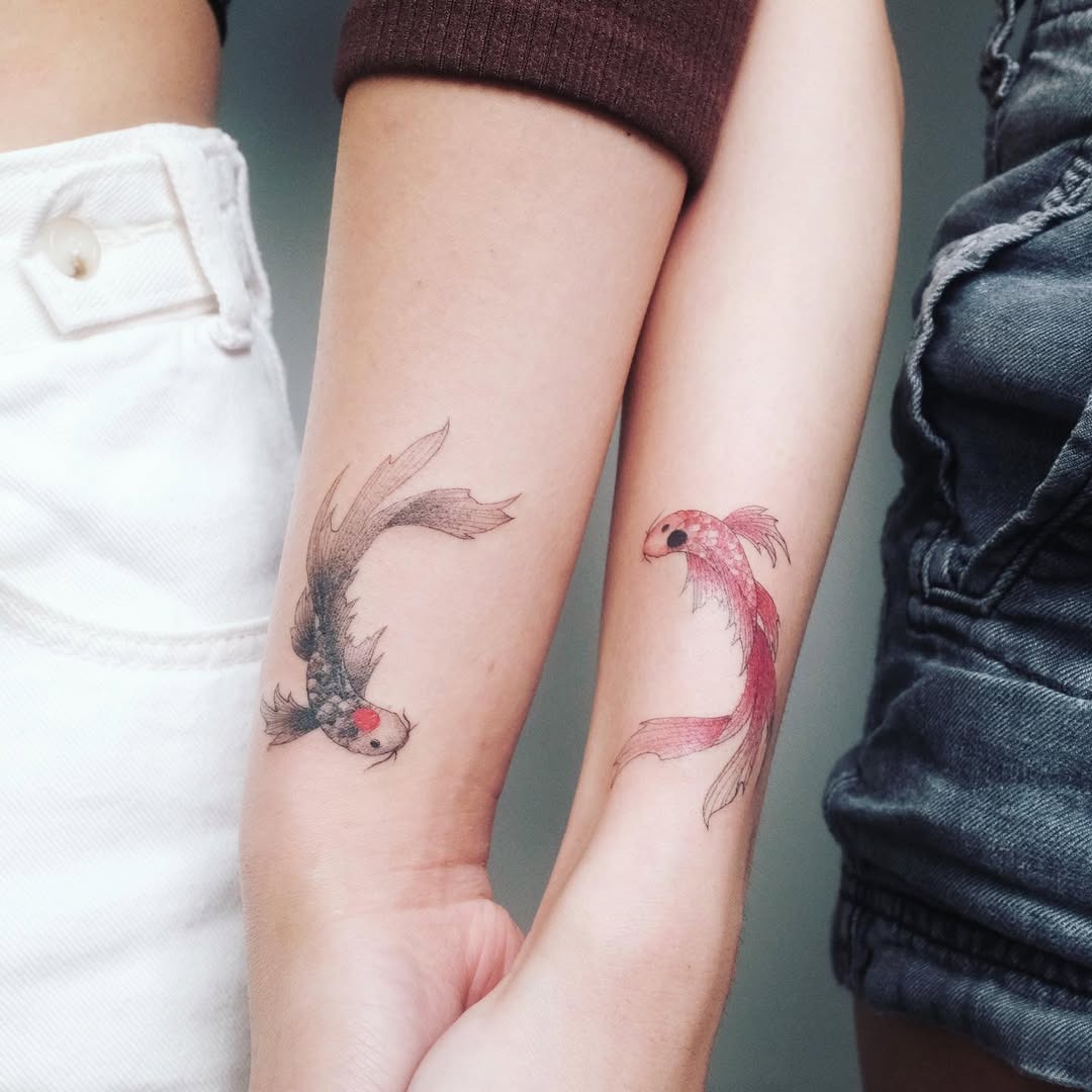 Stylish sister tattoos featuring koi fish. Tattoo Design