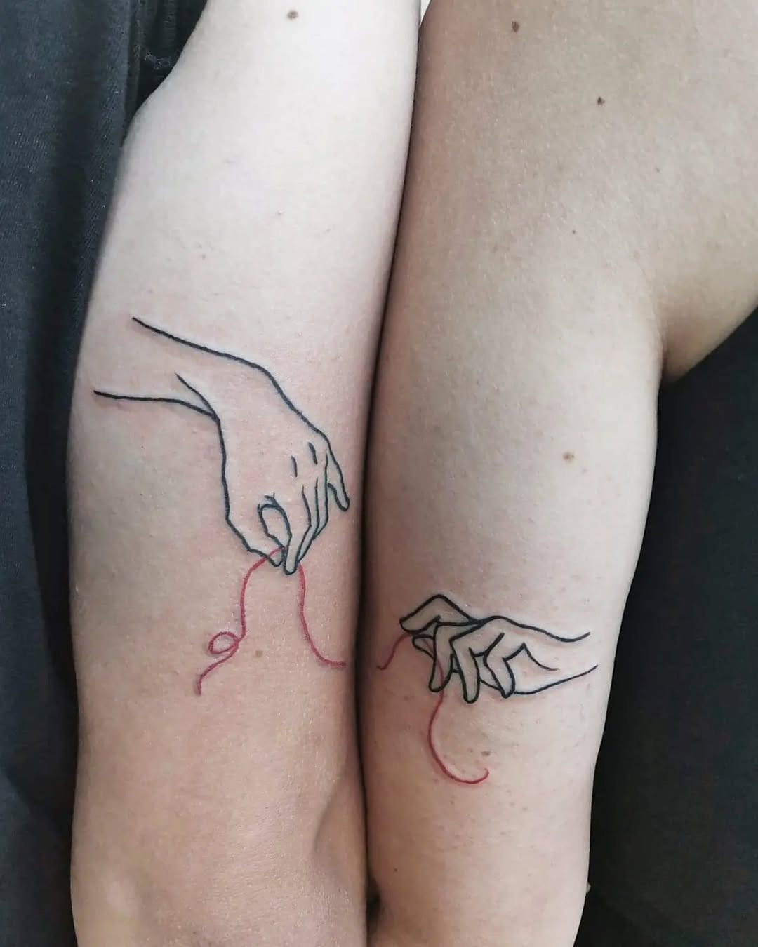 Symbolic sisterhood bond with red threads Tattoo Design