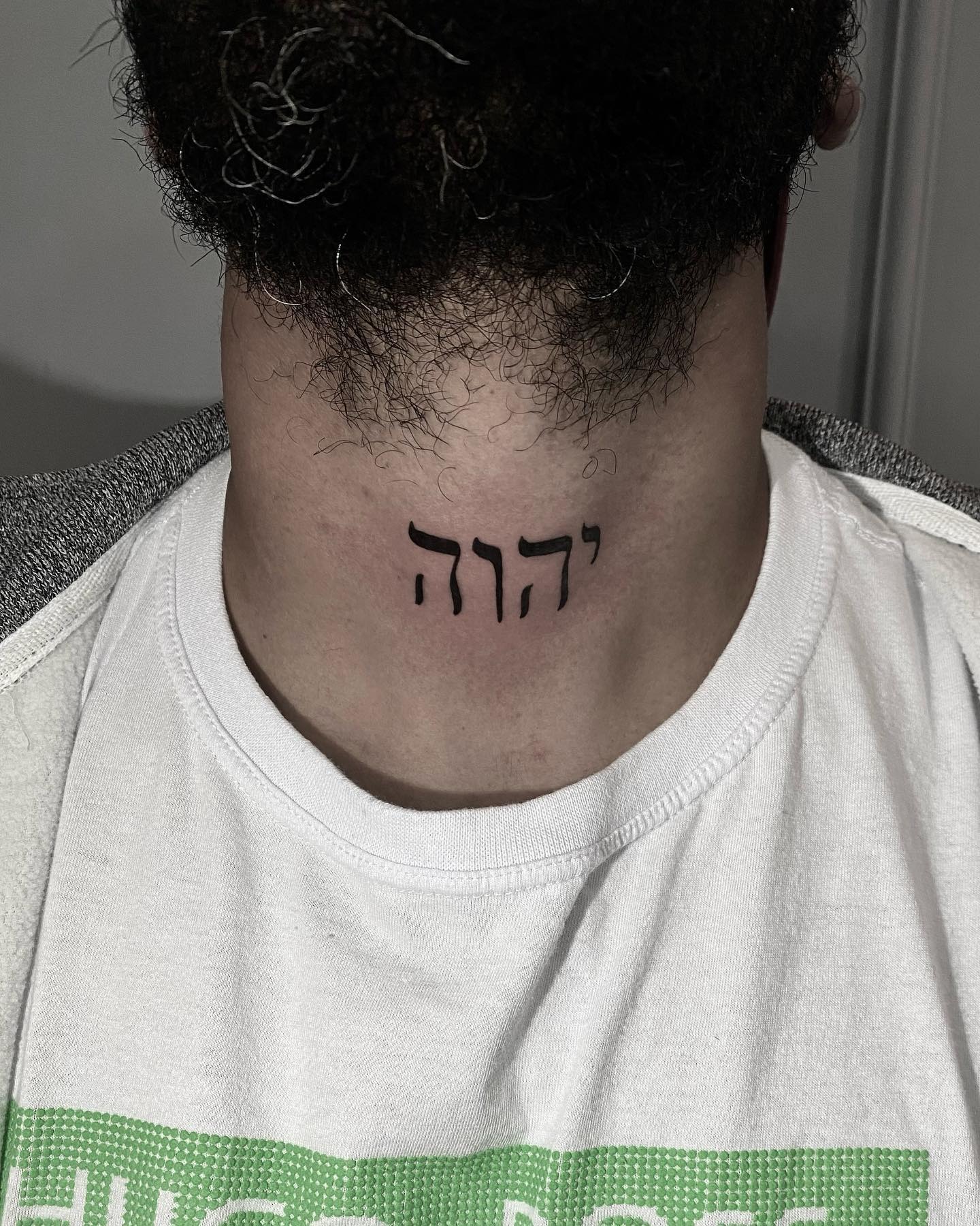 Bold Hebrew Scripture Tattoo on the Neck Tattoo Design