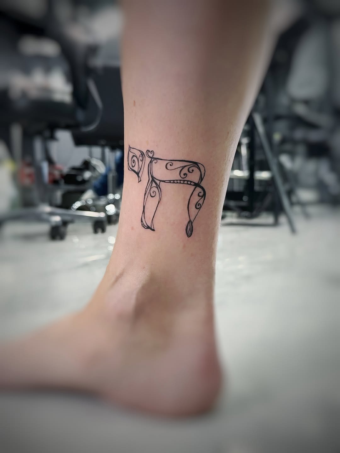 Elegant Hebrew Script Tattoo on Ankle Tattoo Design
