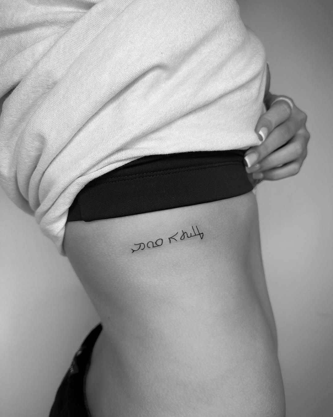 Elegant Hebrew Tattoo on Side of Body Tattoo Design