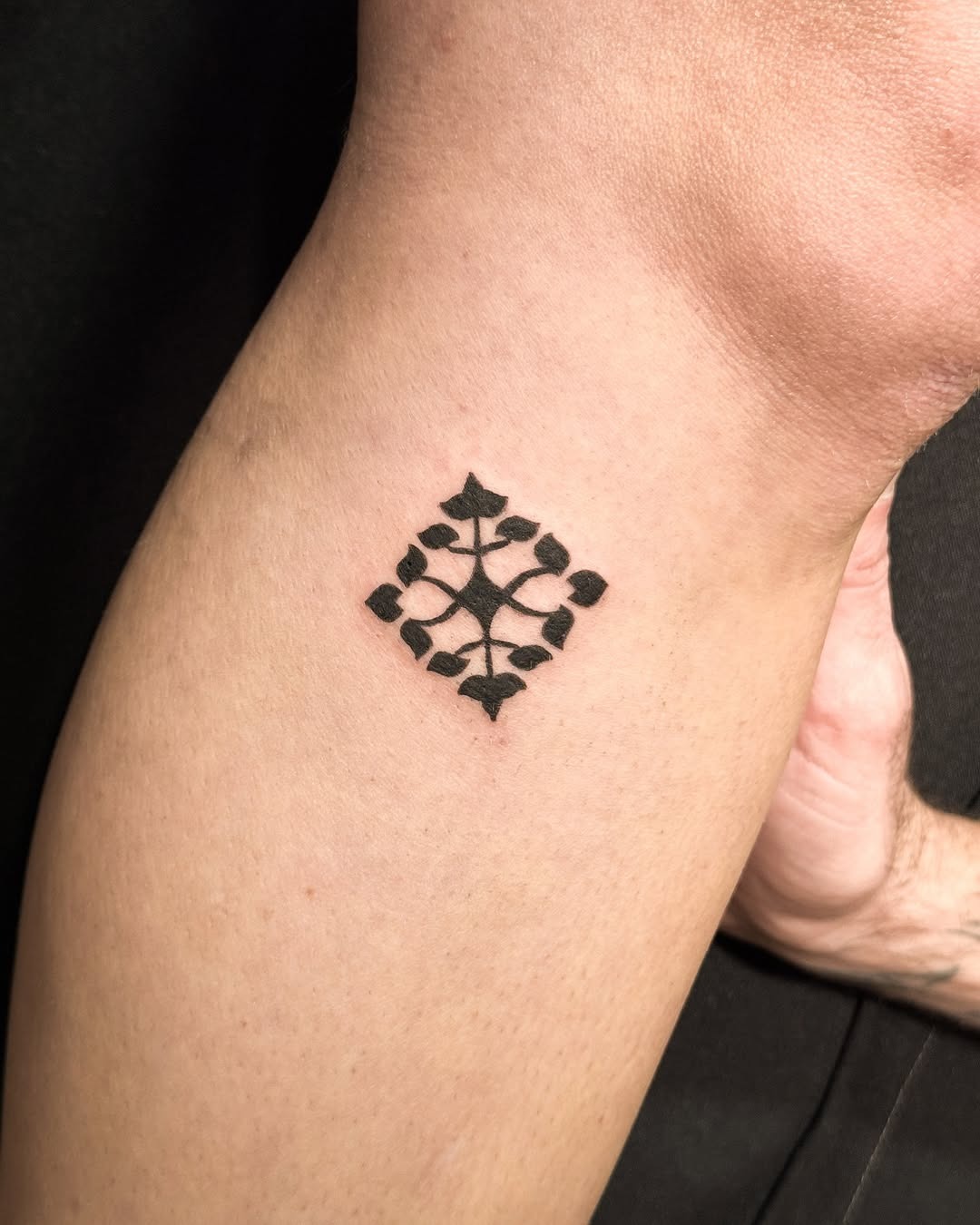 Elegant Hebrew tattoo with leaf motifs Tattoo Design
