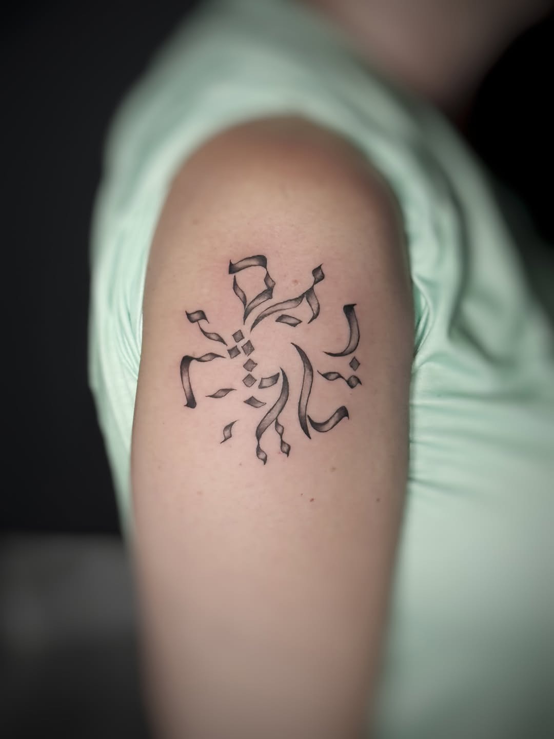 Intricate Hebrew tattoo with flowing lines Tattoo Design