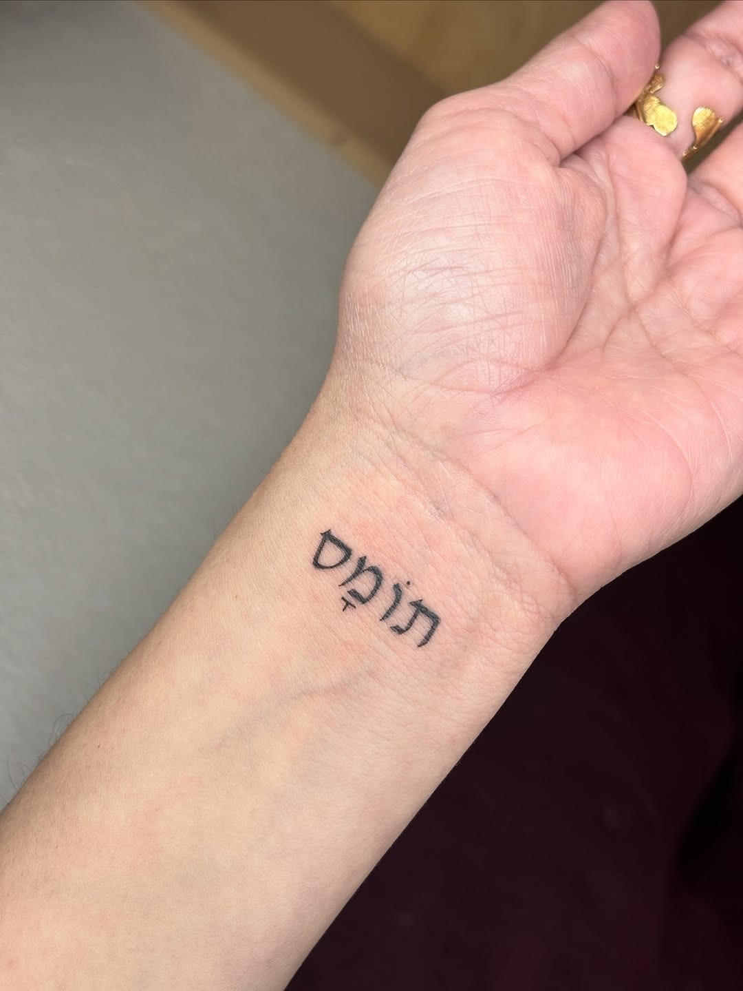 Meaningful Hebrew Tattoo on Wrist Tattoo Design