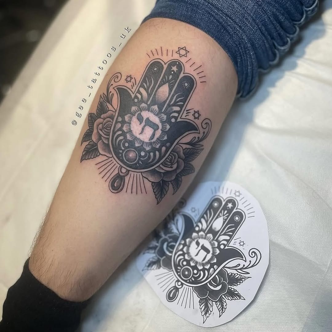 Symbolic Hebrew hand tattoo with floral details Tattoo Design