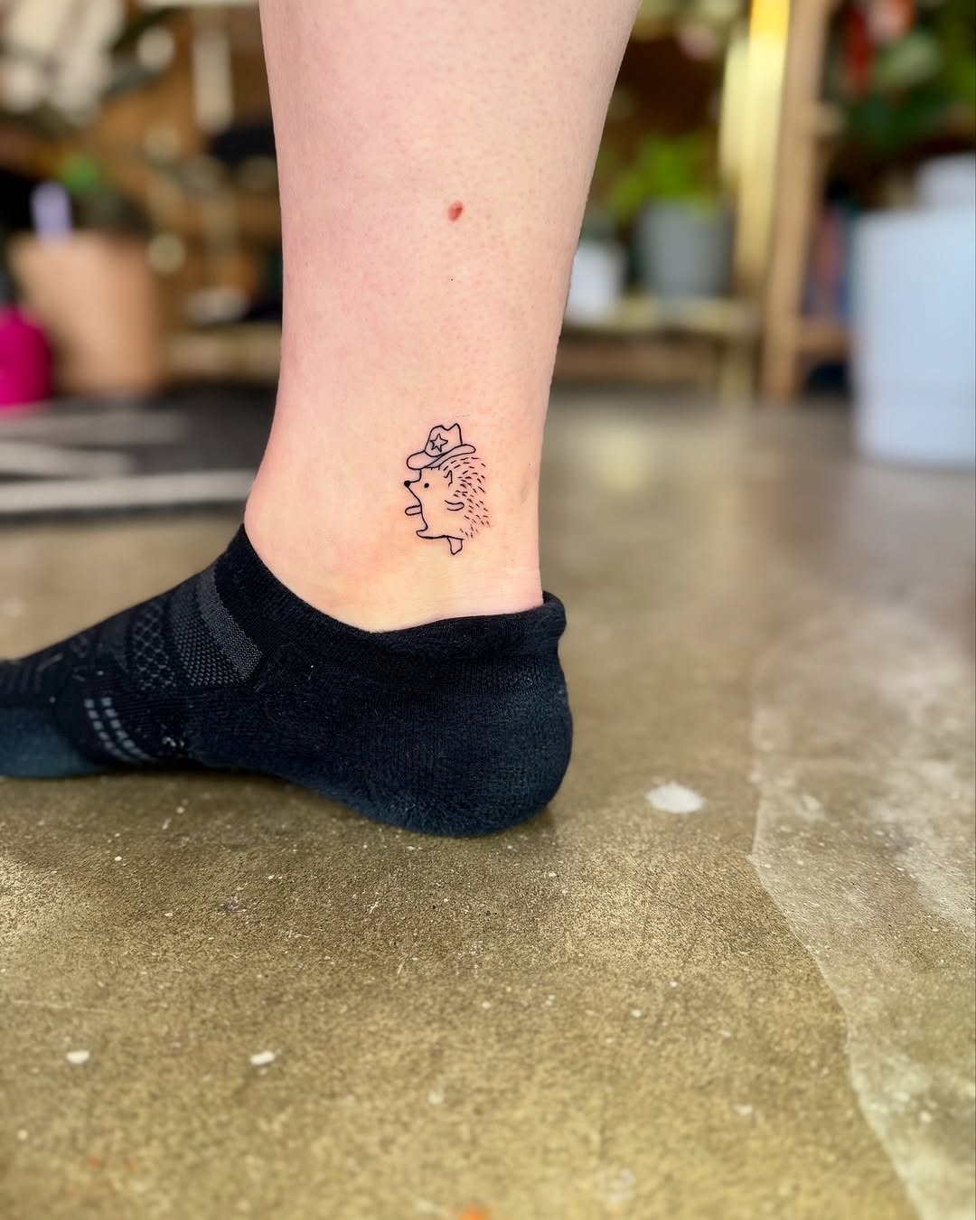 Charming and playful hedgehog tattoo on ankle. Tattoo Design