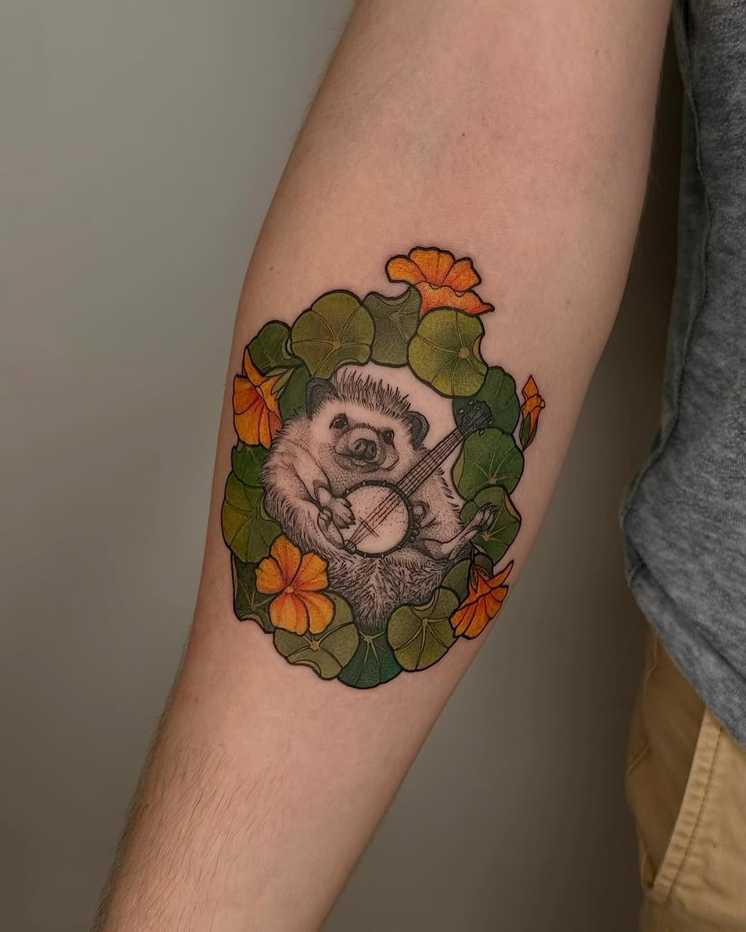 Charming hedgehog playing banjo surrounded by flowers Tattoo Design