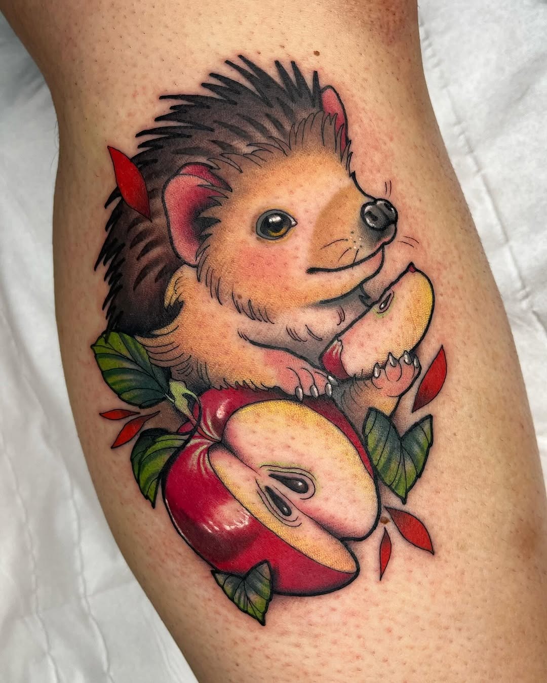 Charming hedgehog tattoo embracing fresh apples Tattoo Design