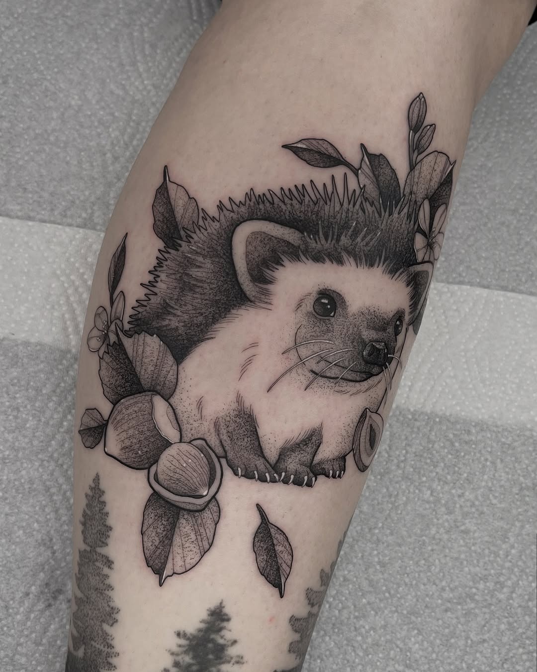 Charming hedgehog tattoo with elegant foliage design Tattoo Design