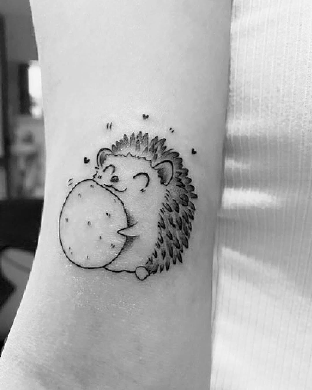 Cute hedgehog tattoo with playful cookie design Tattoo Design