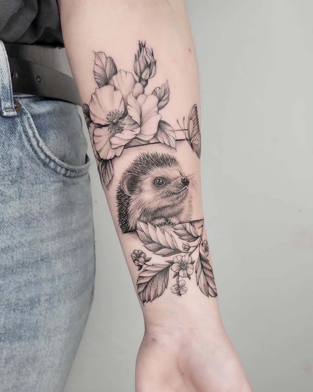 Stunning hedgehog tattoo with floral accents Tattoo Design