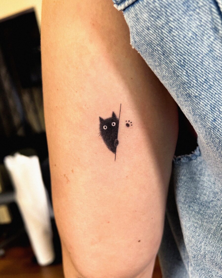 Cute hidden tattoo of a peeking kitten Tattoo Design