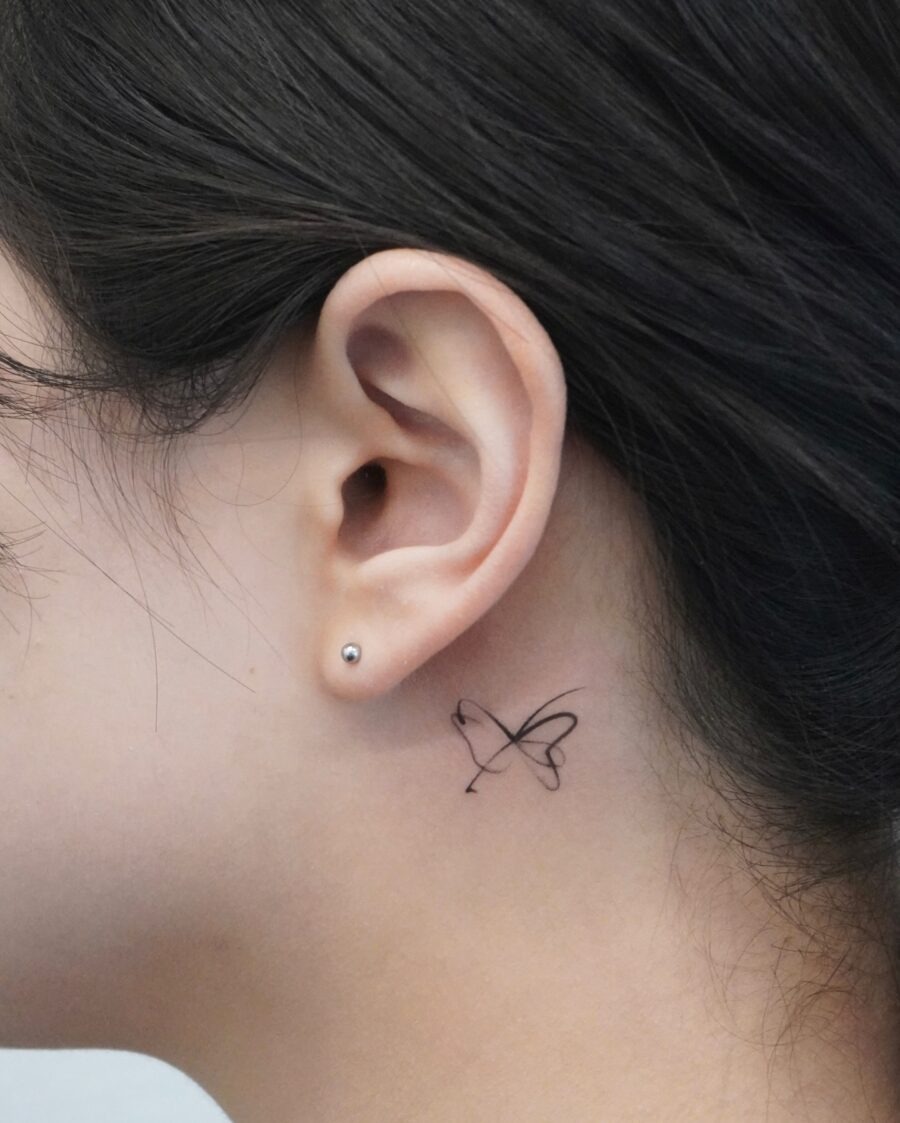 Delicate butterfly tattoo just behind the ear Tattoo Design