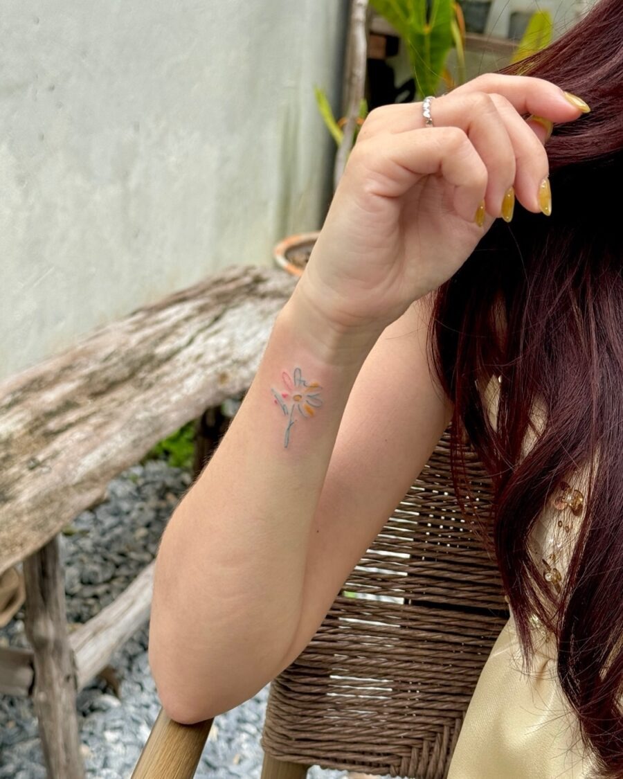 Delicate floral tattoo subtly hidden on arm Tattoo Design