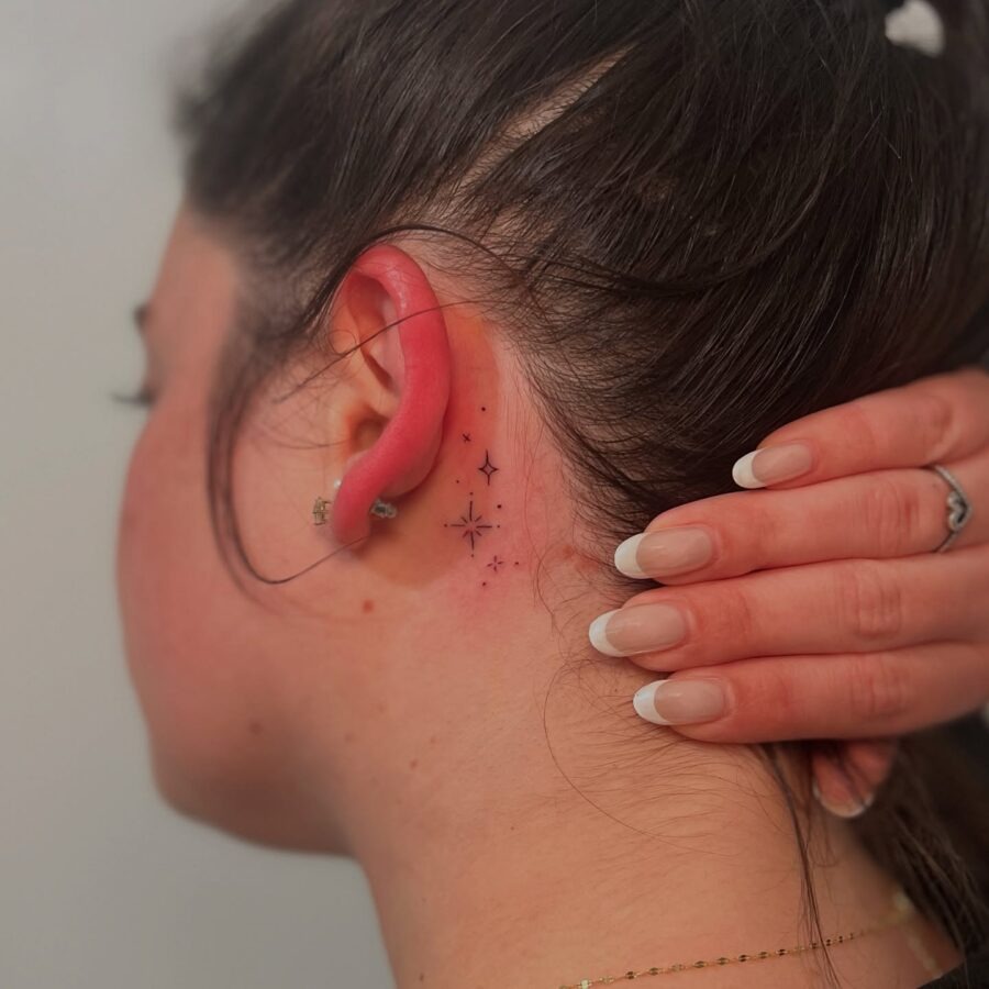 Delicate stars tattoo hidden behind the ear Tattoo Design