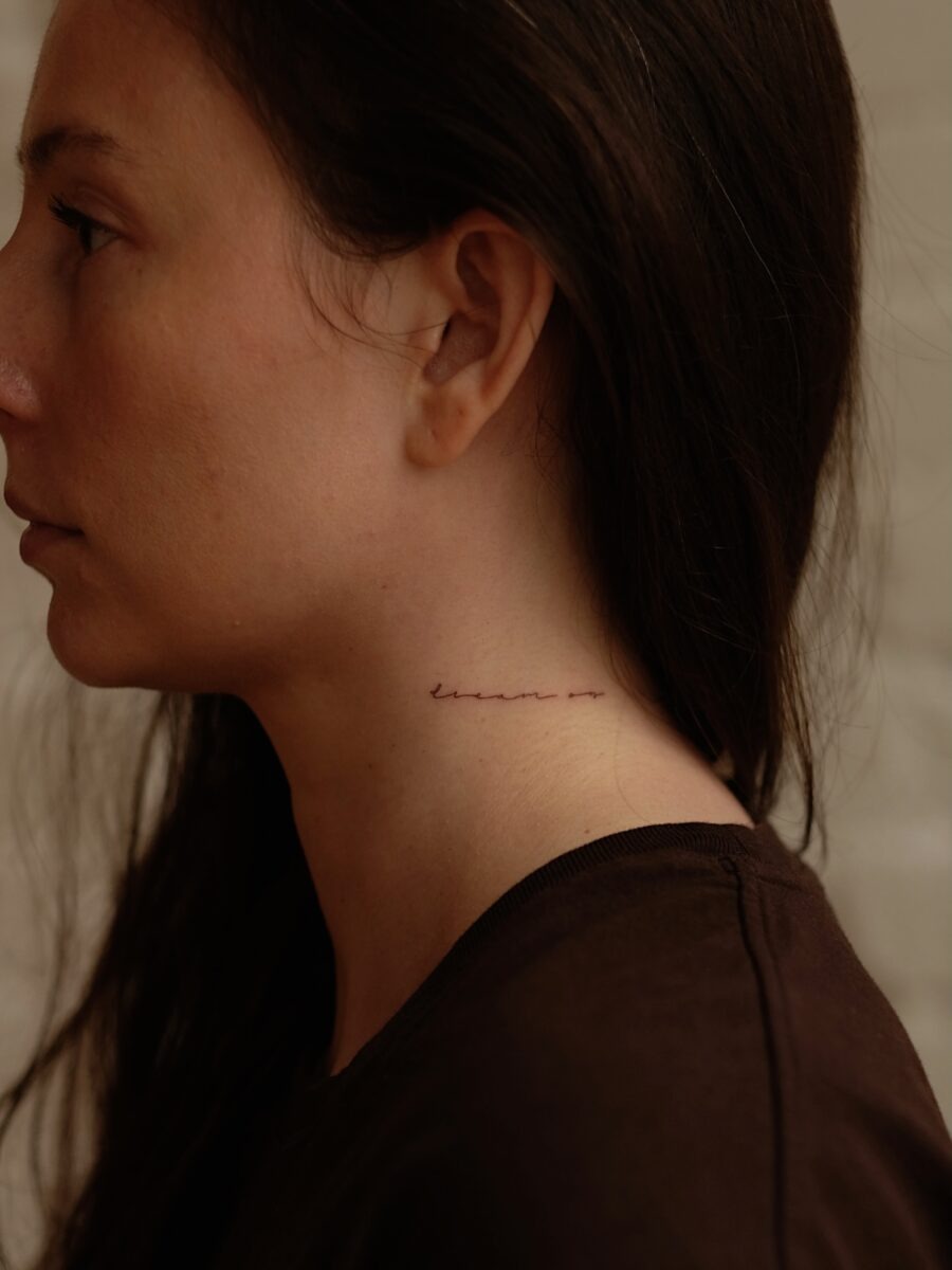 Elegant script tattoo on the neck Tattoo Design
