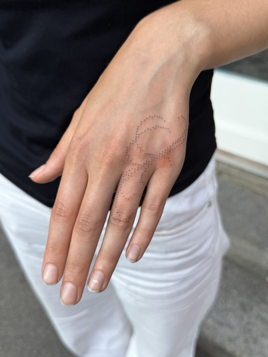 Intricate hand tattoo blending elegance and mystery Tattoo Design
