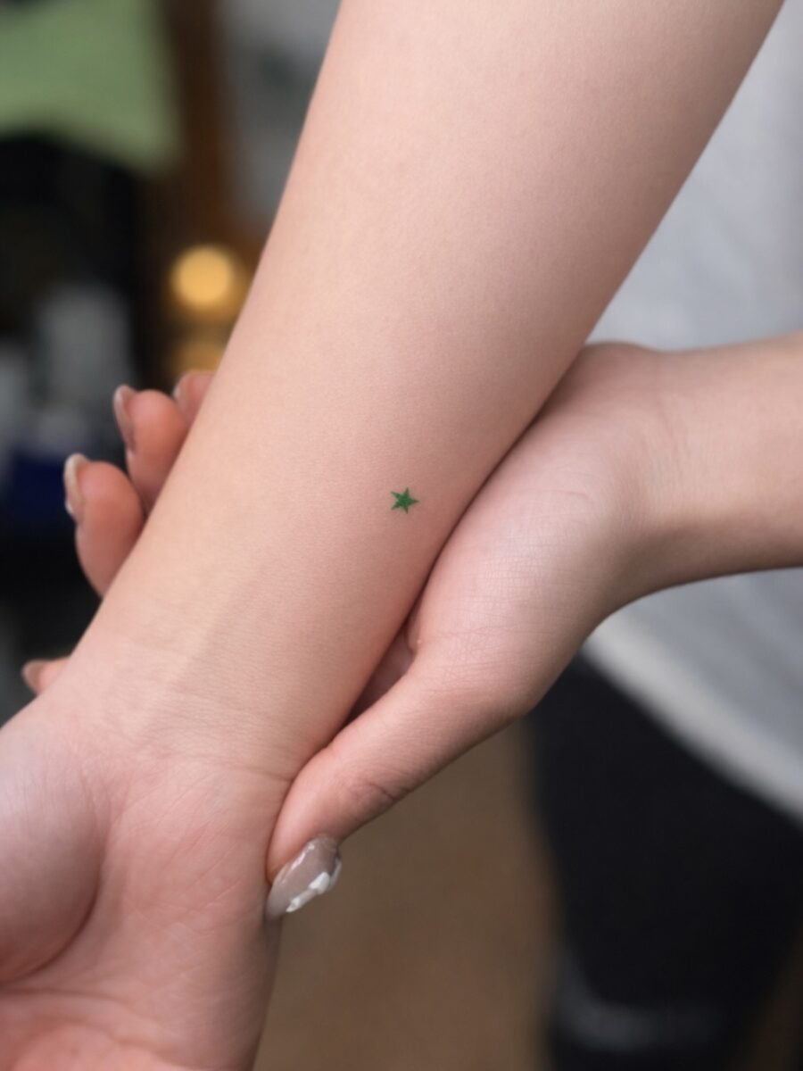 Minimalist green star tattoo on the arm Tattoo Design