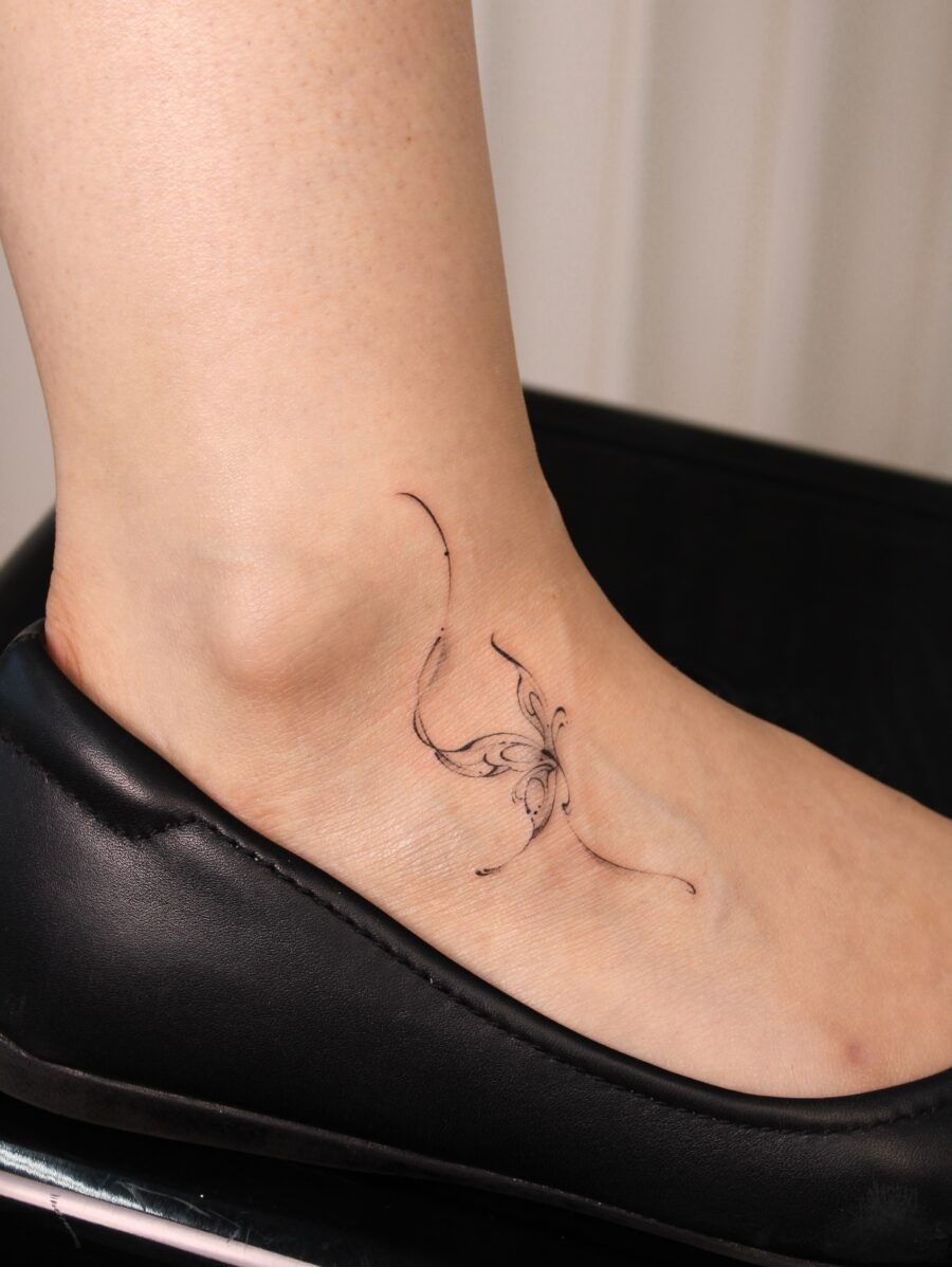 Subtle butterfly tattoo on the ankle area Tattoo Design