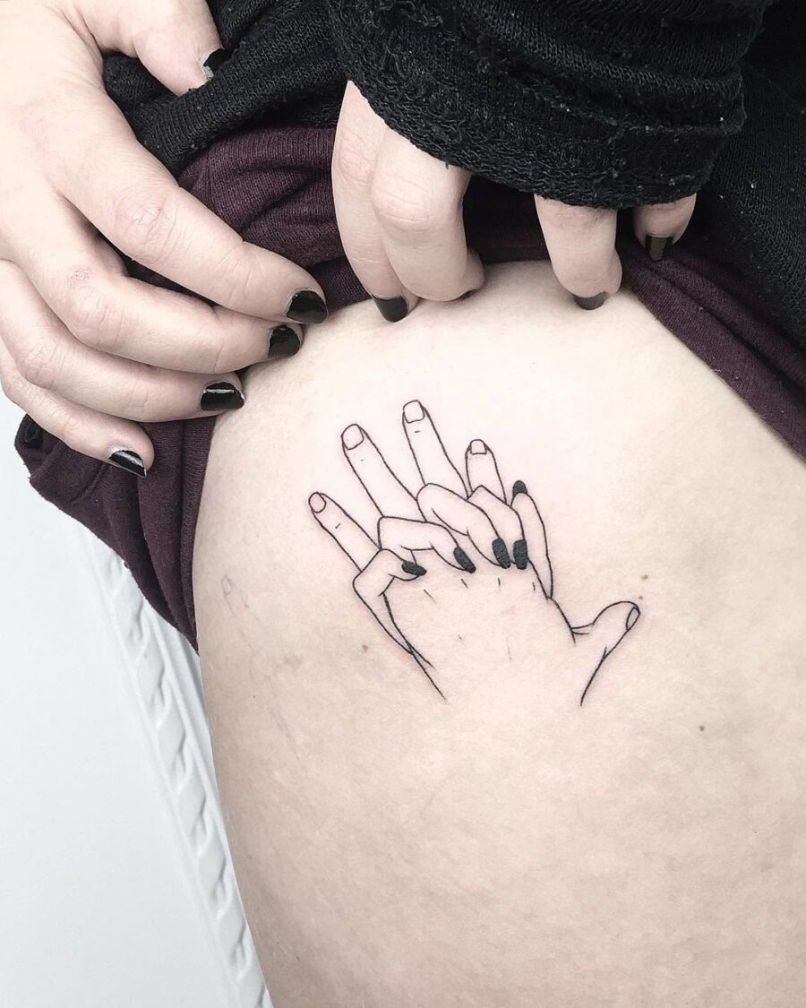 Delicate holding hands tattoo on thigh Tattoo Design