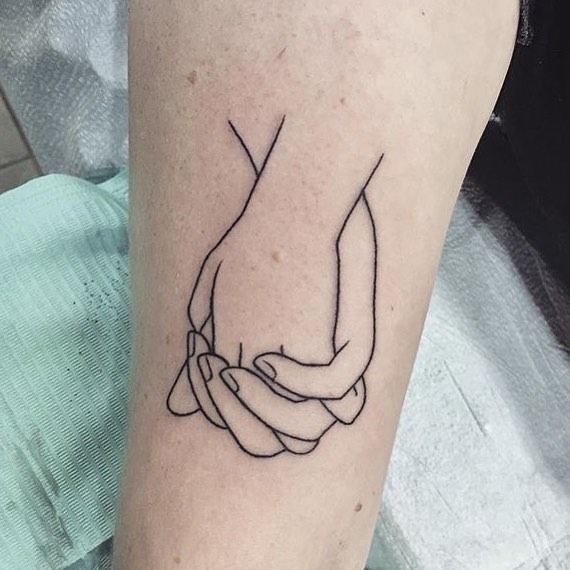 Delicate minimalist hands entwined in ink Tattoo Design