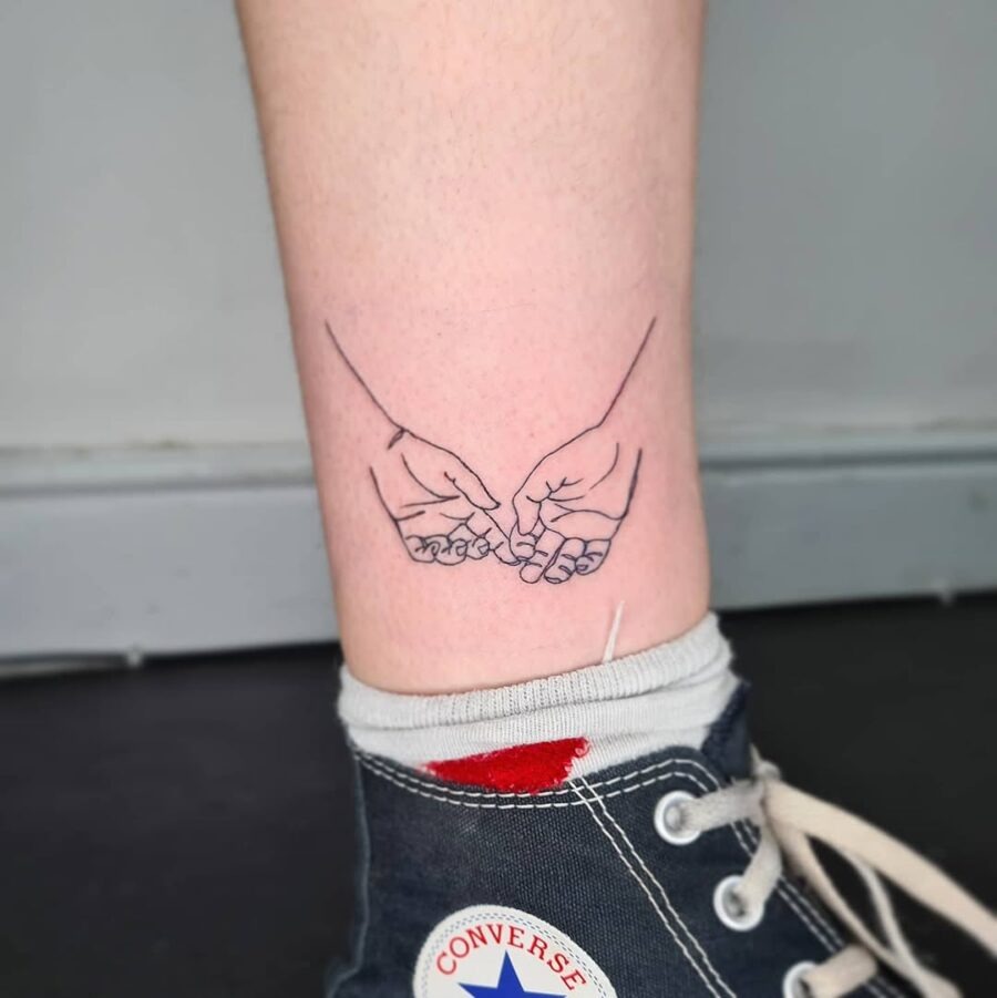 Delicate tattoo of hands intertwining peacefully Tattoo Design