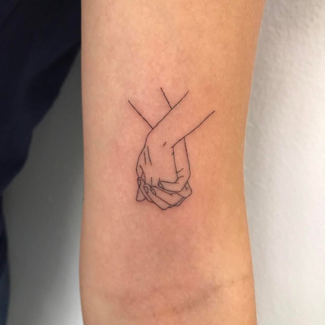 Minimalistic tattoo of intertwined hands design Tattoo Design
