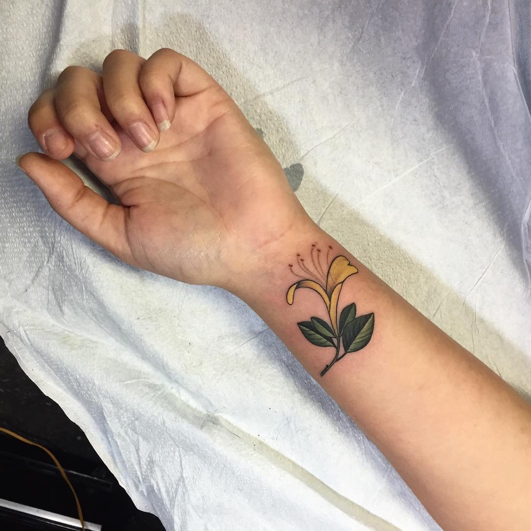 This honeysuckle tattoo beautifully graces the wrist.