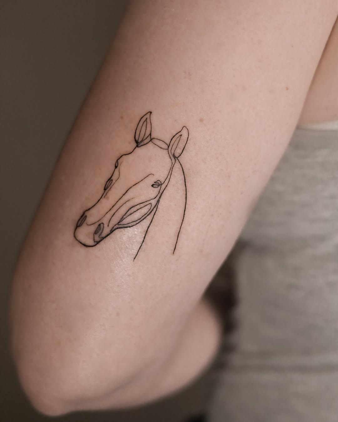 Elegant Minimalist Horse Tattoo in Line Art Tattoo Design