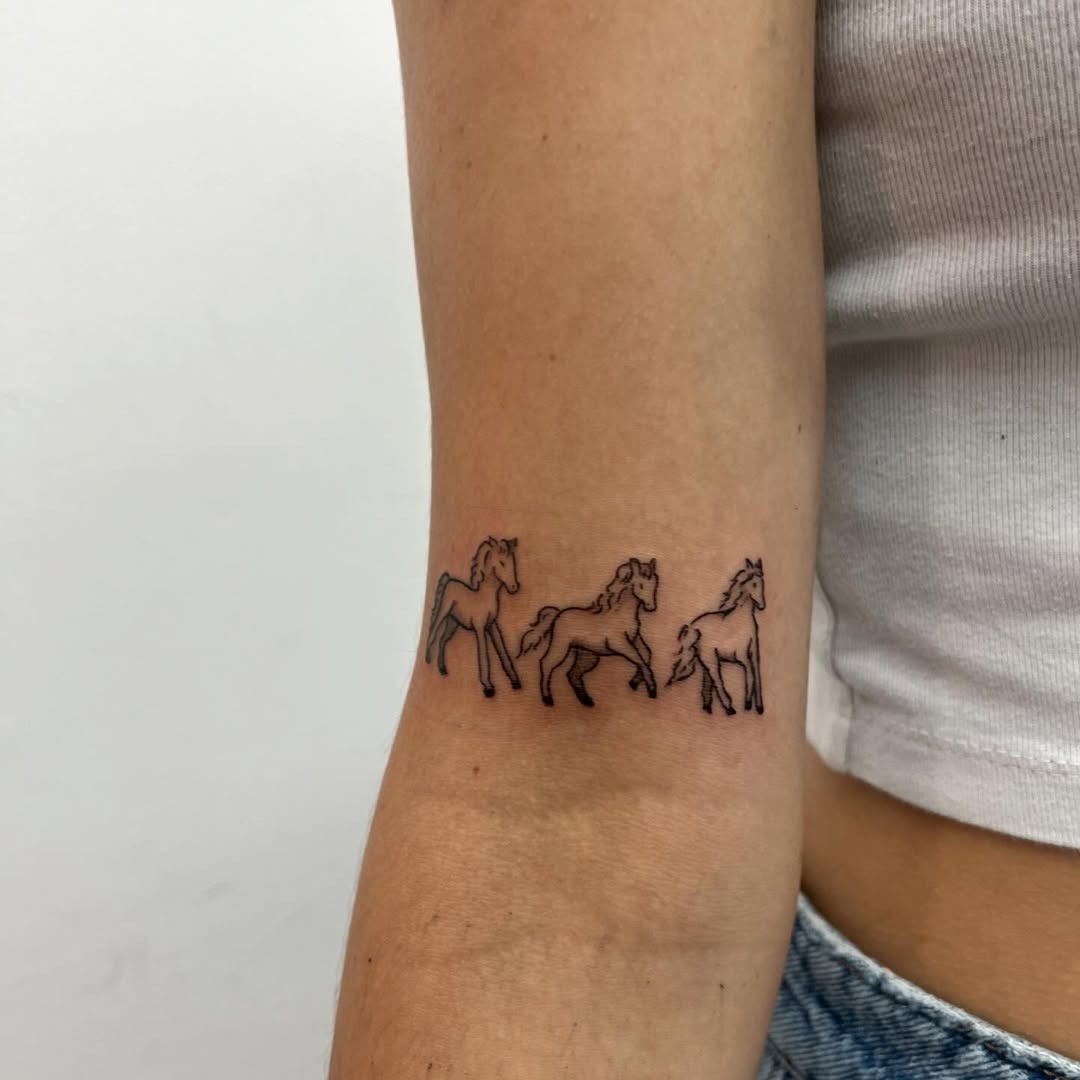 Elegant minimalist horses in fine line strokes Tattoo Design