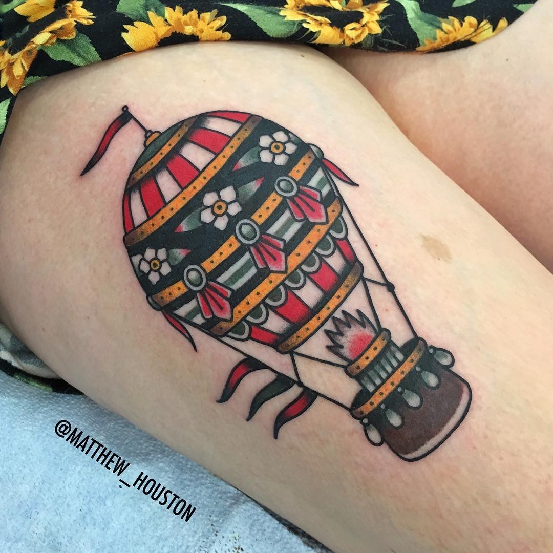 This hot air balloon tattoo features a mix of colors and intricate details.