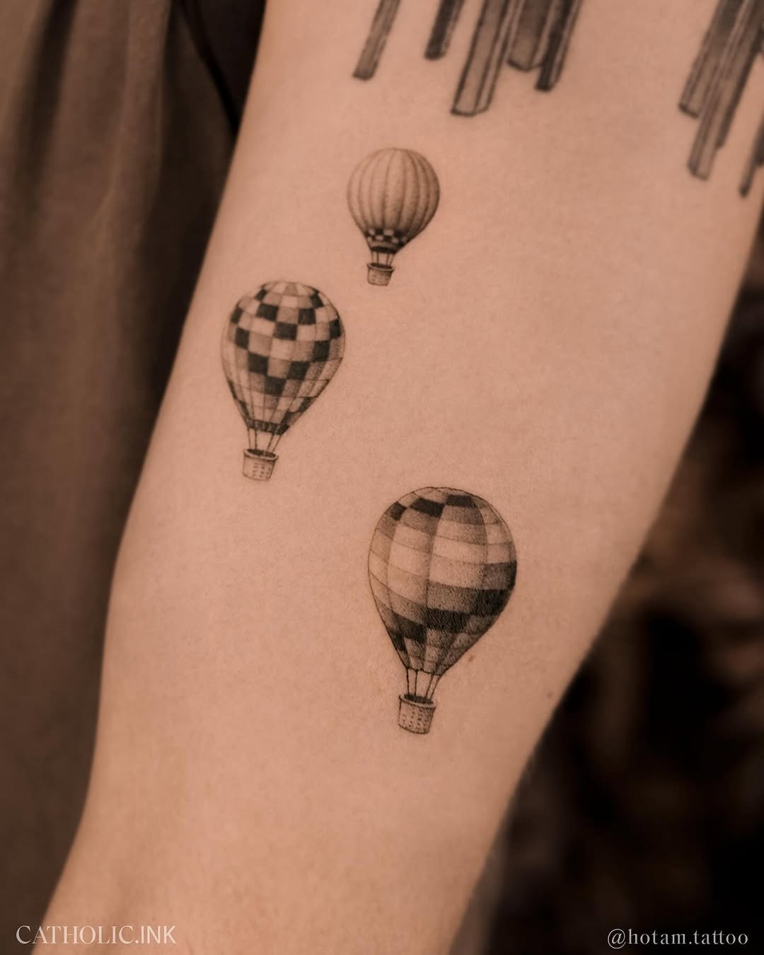 This image features three stylish hot air balloon tattoos in a black and gray palette.