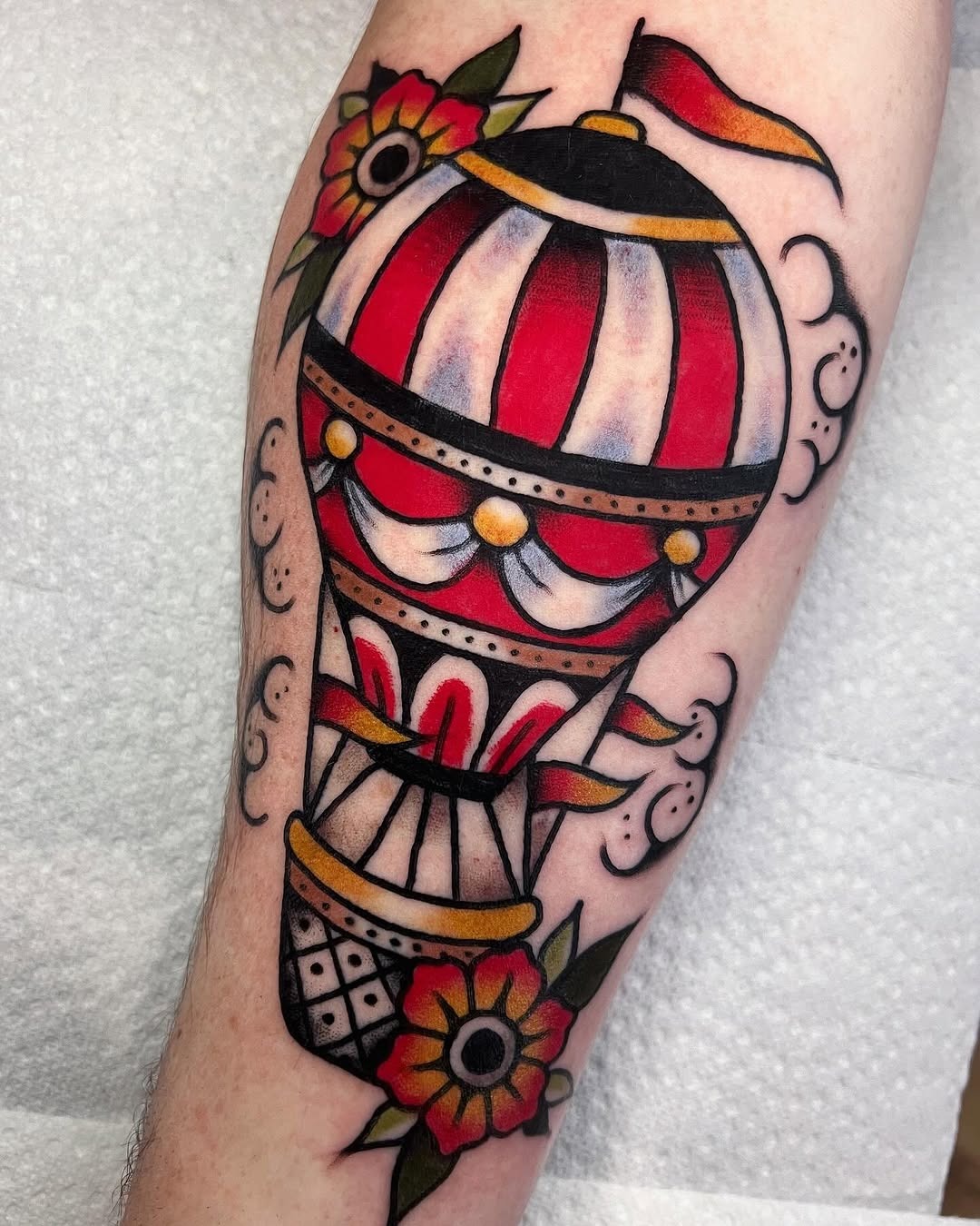 This hot air balloon tattoo combines colors with bold lines for a striking appearance.