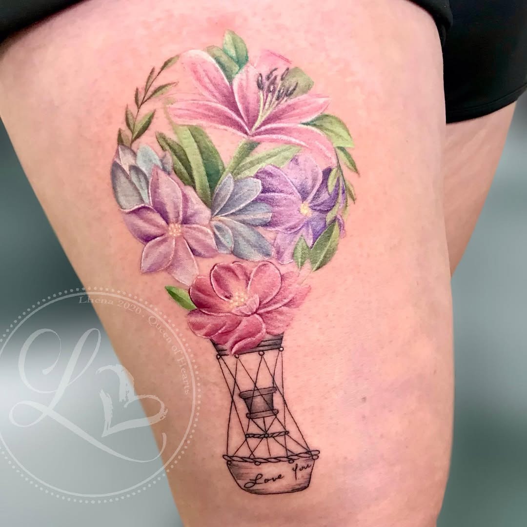 This tattoo features a beautifully crafted hot air balloon that blends flowers with the traditional balloon shape.