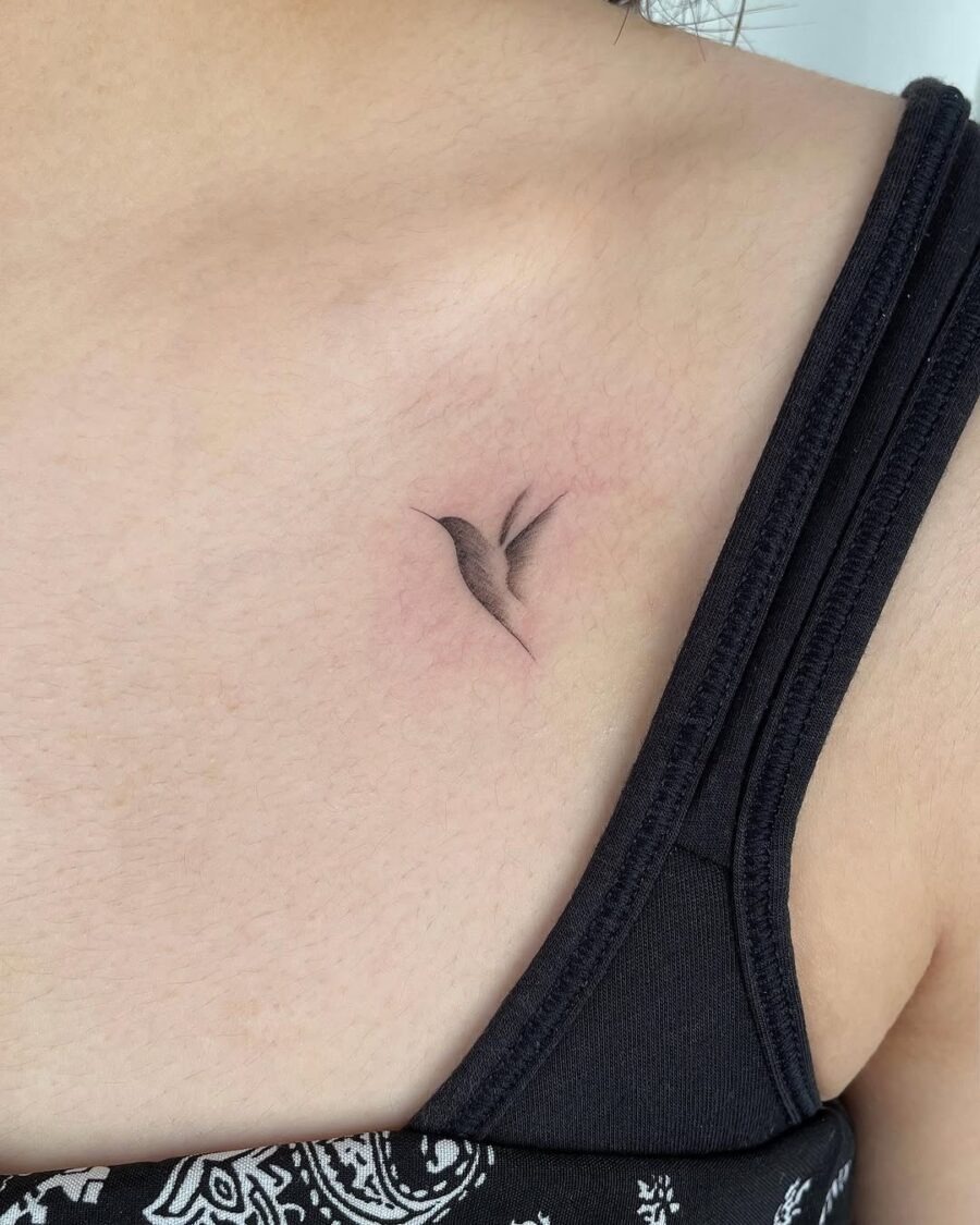 A graceful hummingbird in delicate black ink Tattoo Design